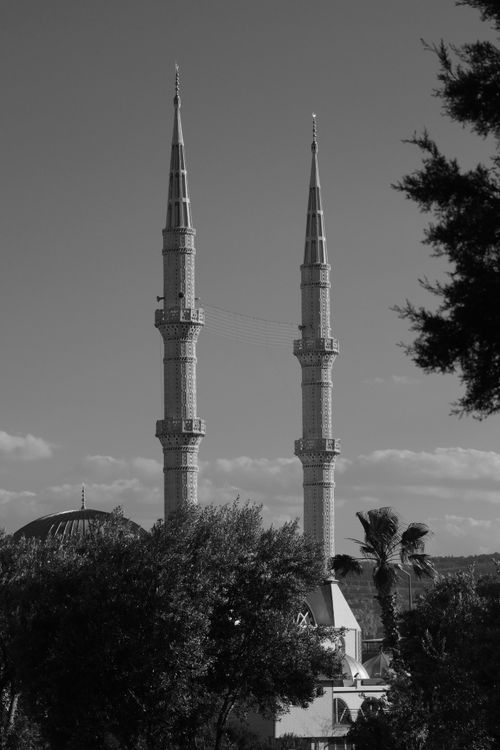 Free Elegant twin minarets of a mosque captured in İzmir, showcasing classic Islamic architecture. Stock Photo