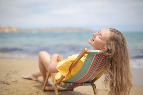 Woman Reclining on Wooden Folding Chair