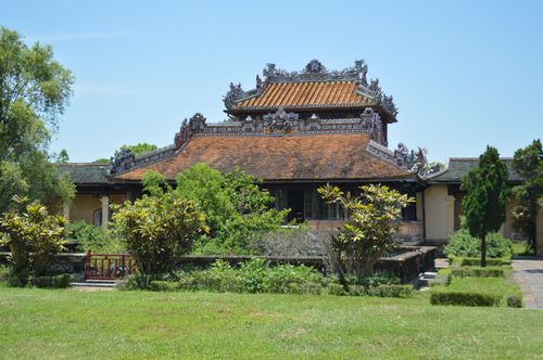 Free Discover this traditional Vietnamese pagoda surrounded by vibrant greenery under a clear blue sky. Stock Photo