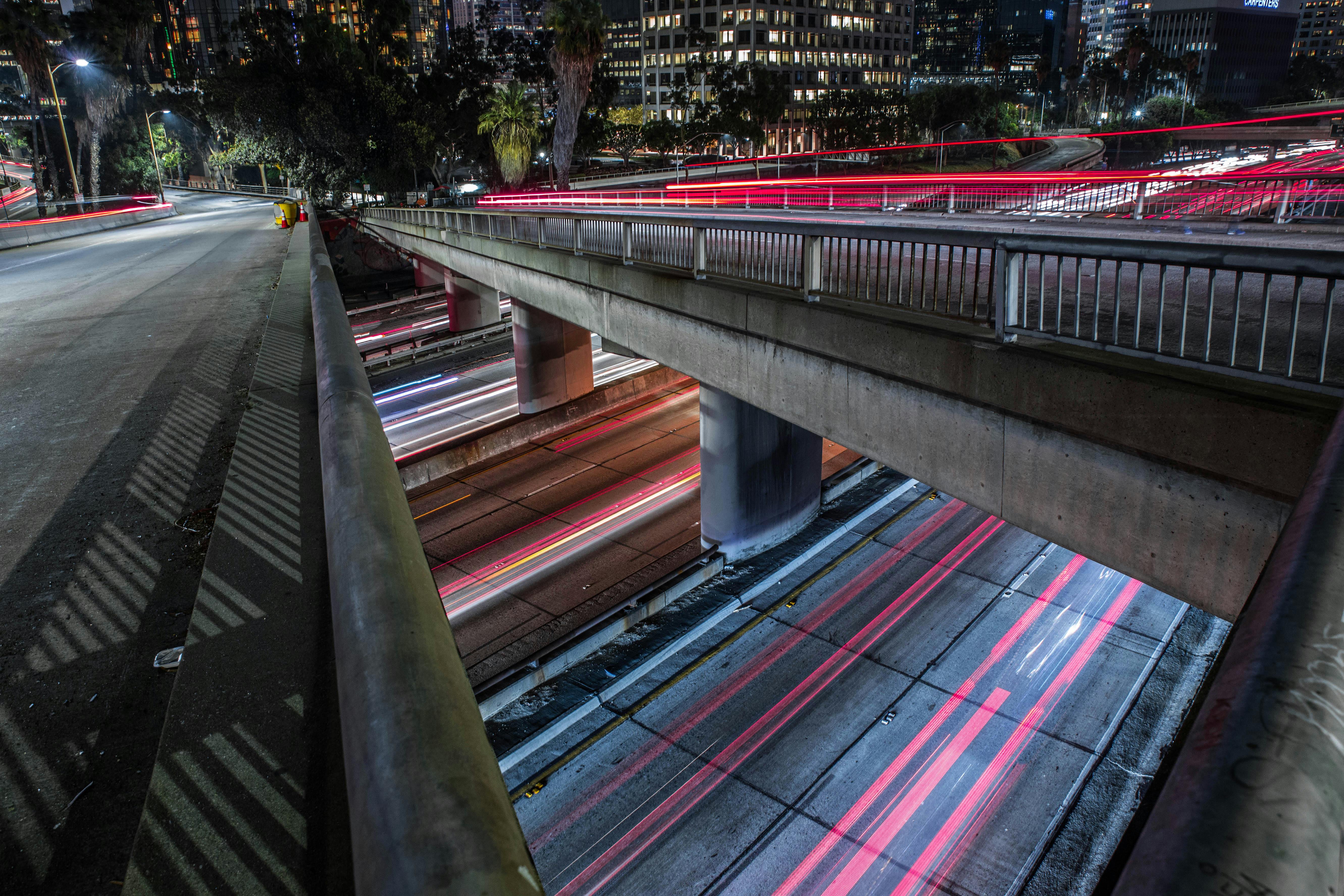 timelapse photography of vehicles traveling bridge and road at night