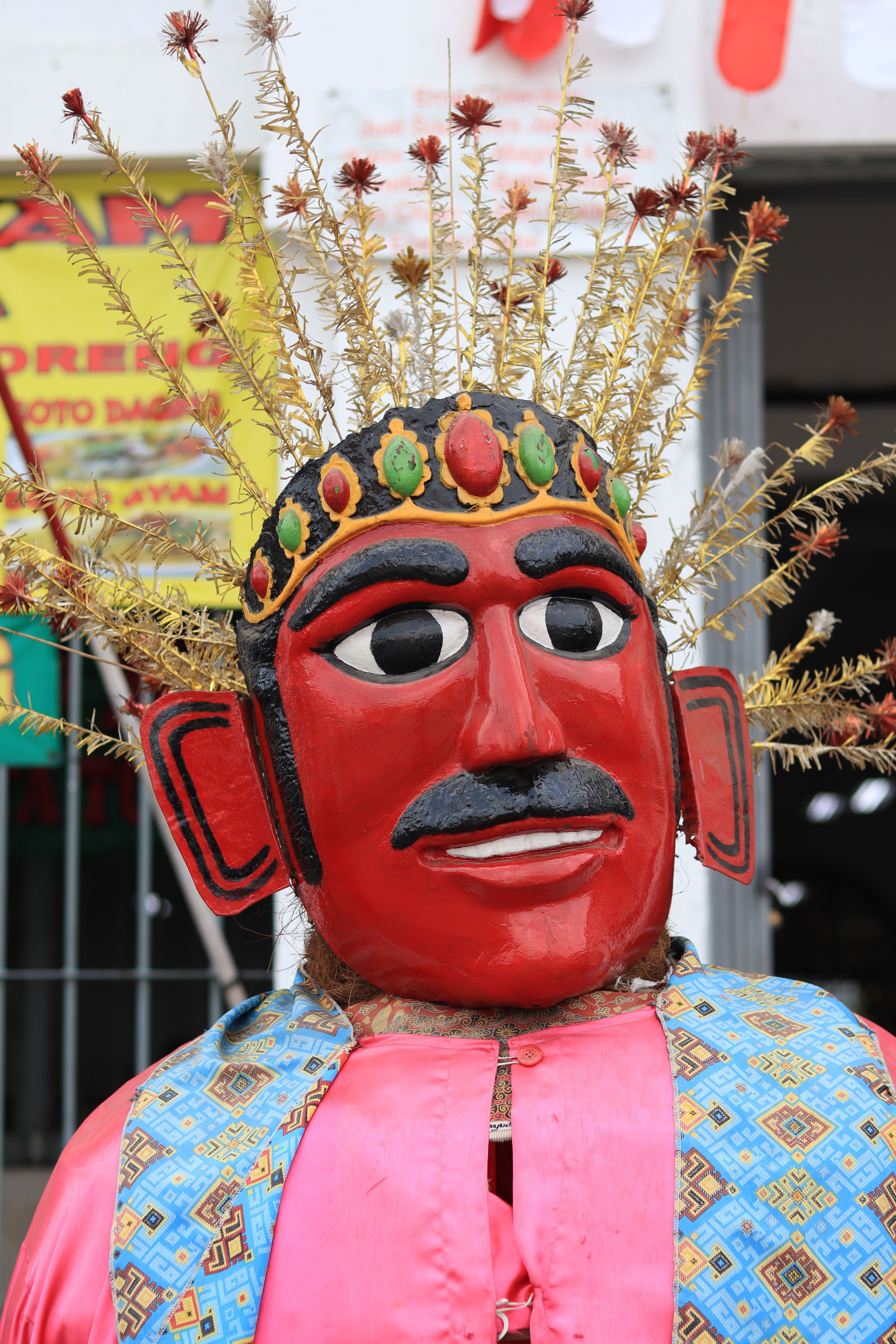 Colorful Ondel-Ondel puppet with intricate design in Jakarta, Indonesia's cultural street.