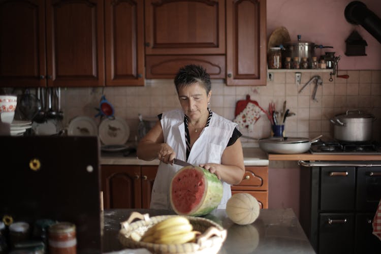 Woman Slicing A Watermelon