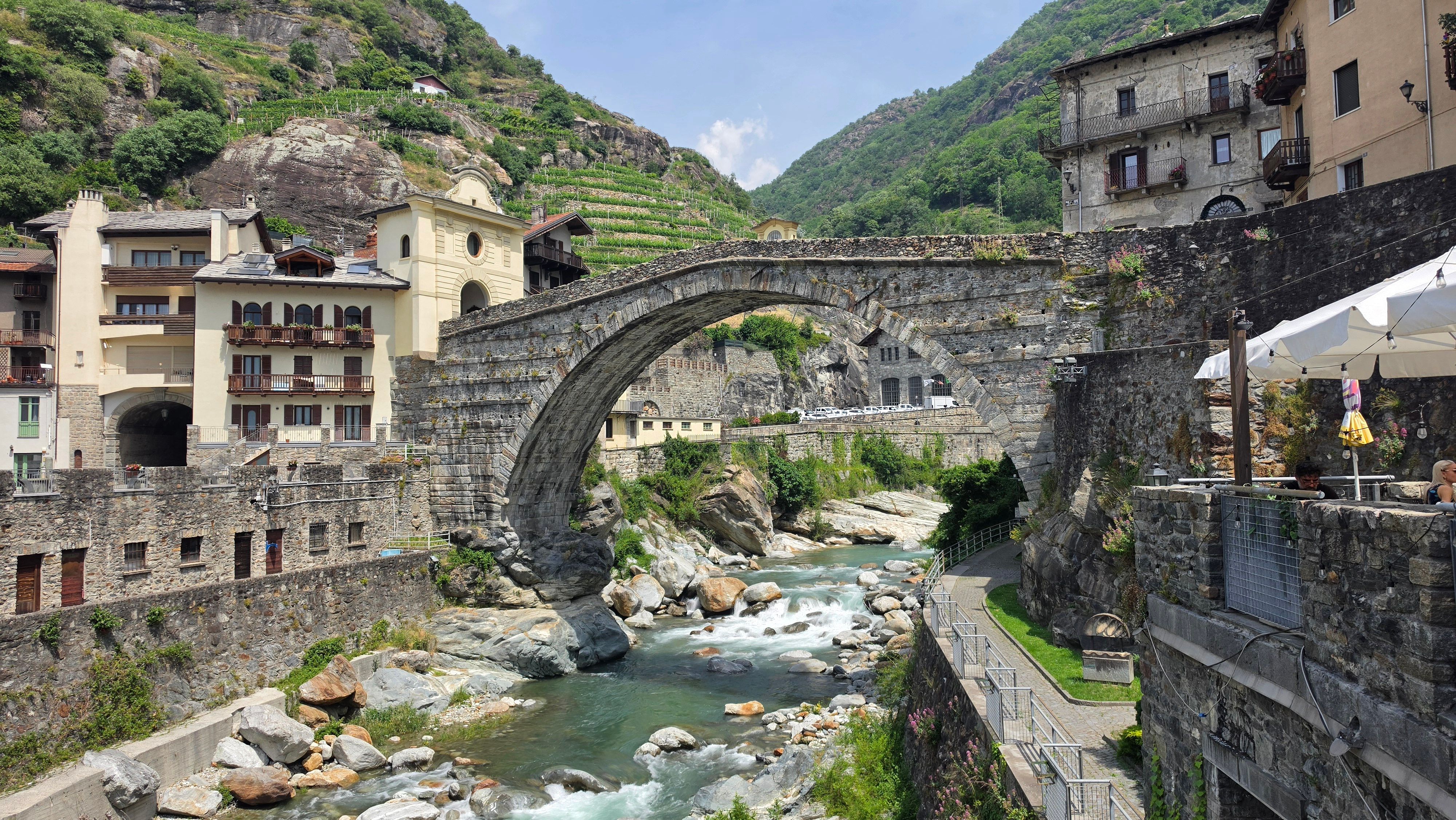 Picturesque Roman bridge over a river in Pont-Saint-Martin, Italy.