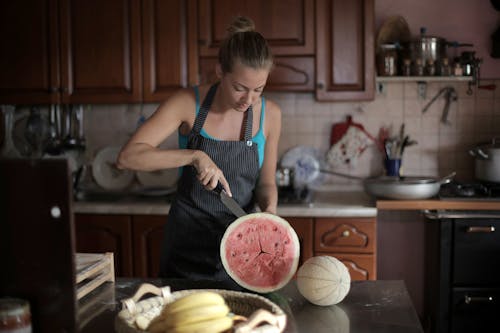 Free Woman Slicing Watermelon Stock Photo