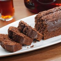 Sliced chocolate loaf cake on a white plate, photo by Swarup Sarkar on Pexels