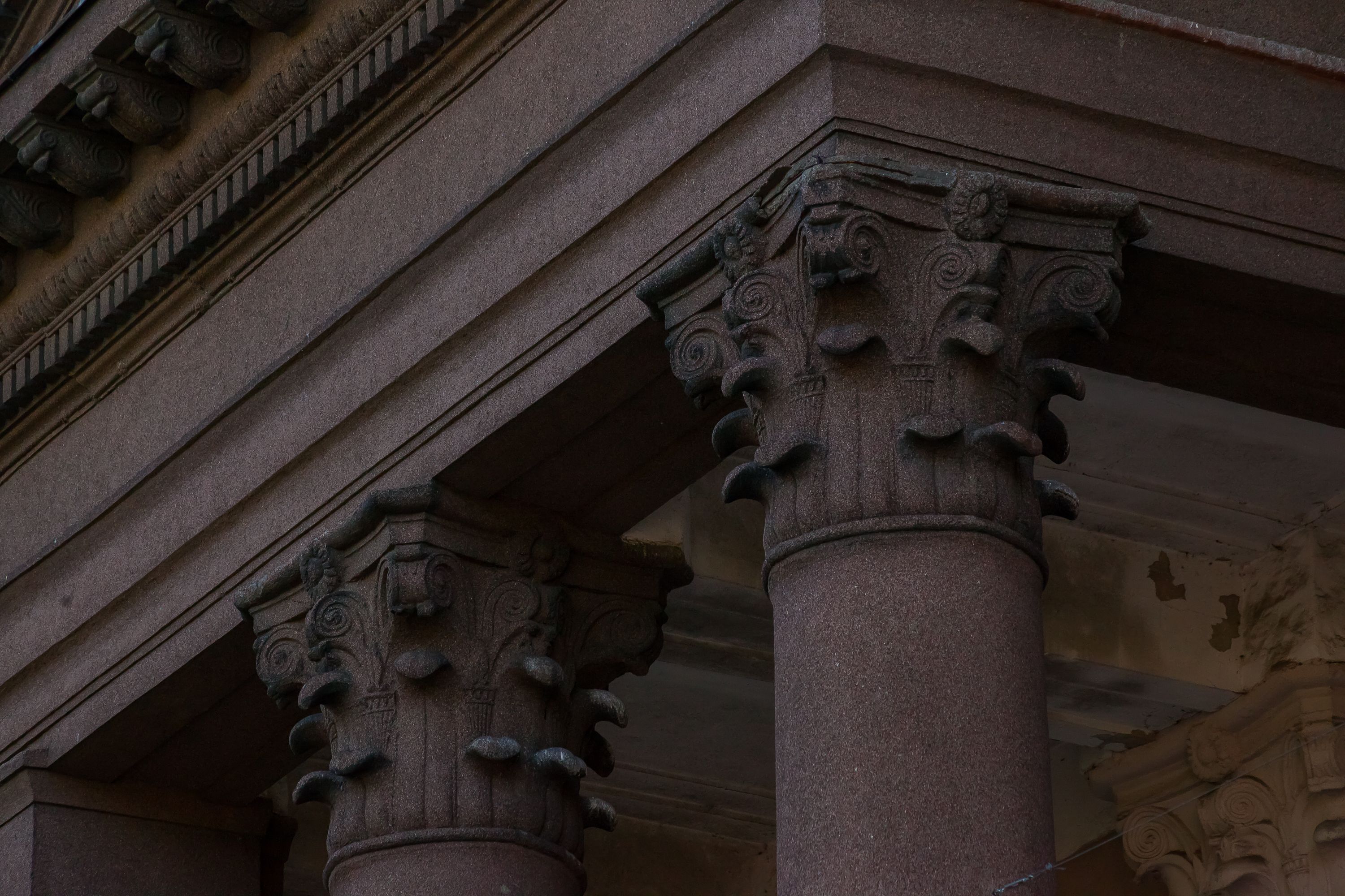 Detailed view of ornate classical columns in an architectural setting.