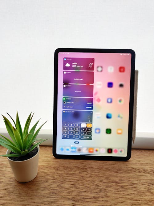 Black Ipad on Brown Wooden Table