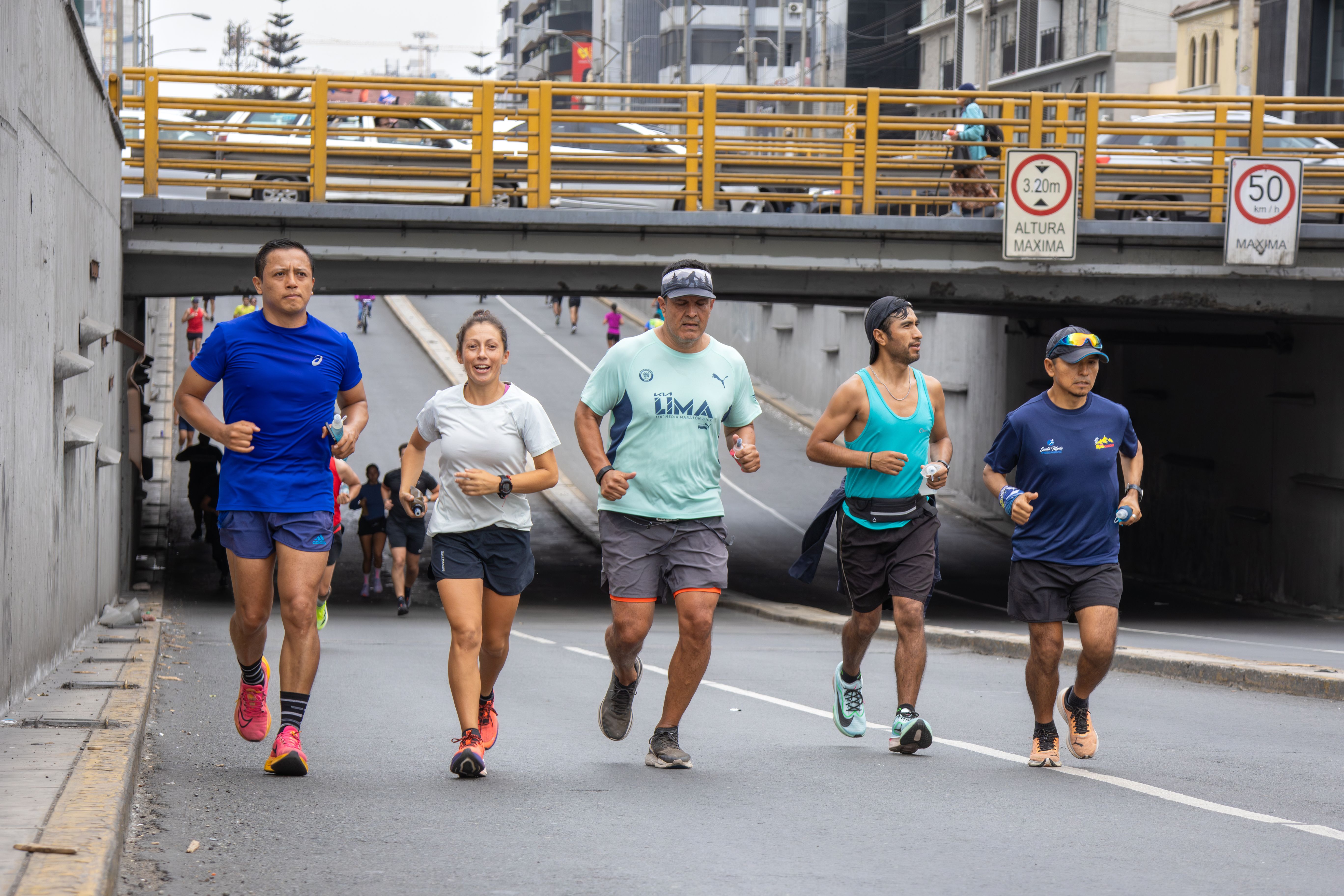 A group of adults jogging together in an urban setting in Lima, showcasing healthy lifestyle and teamwork.
