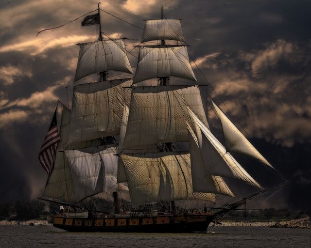 Sailing ship under a dark, stormy sky — photo by Pixabay on Pexels