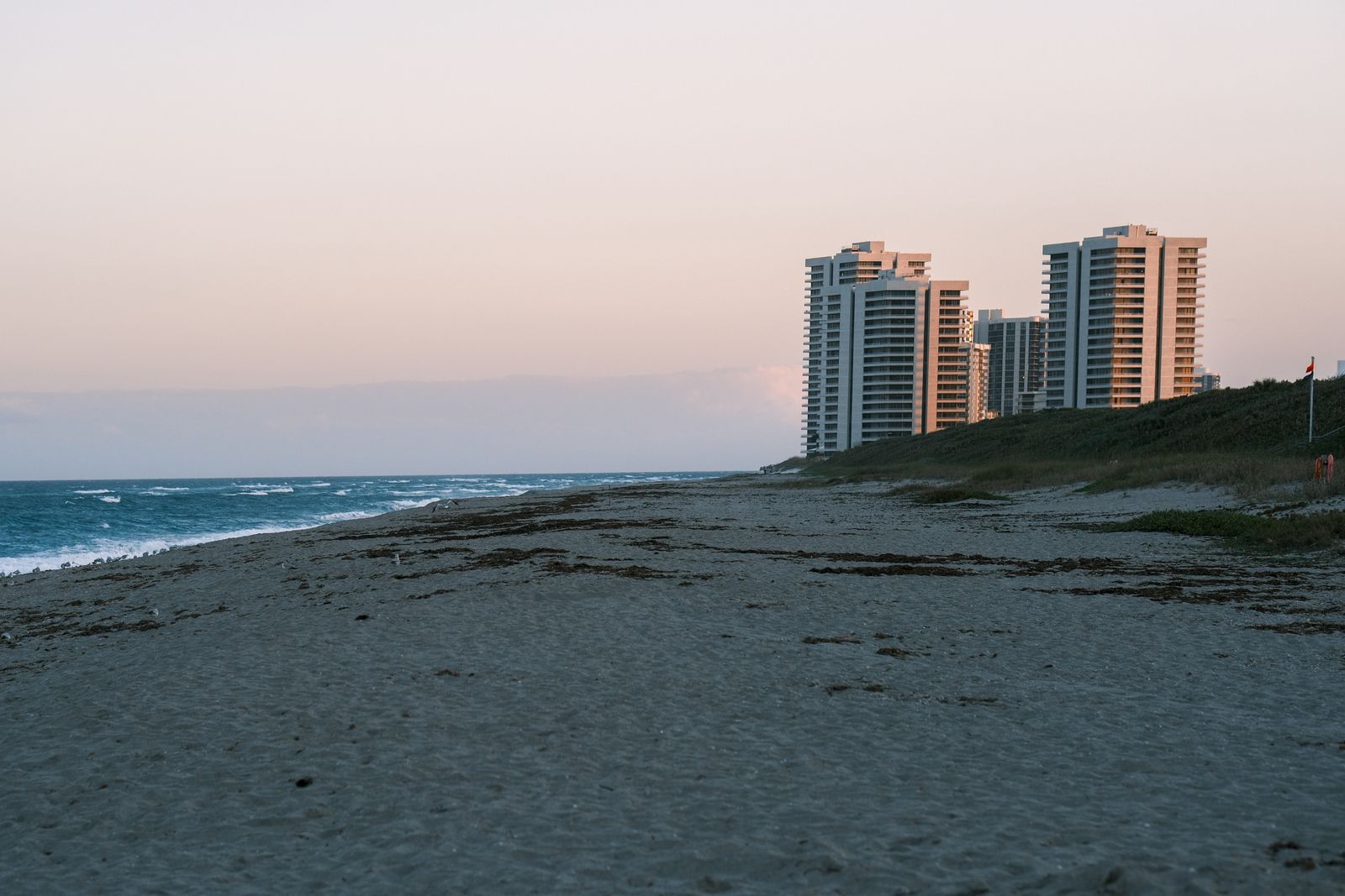 Beachfront towers with a calm sea at sunset