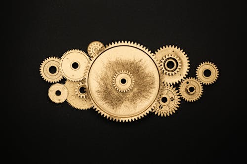 Photo of Golden Cogwheel on Black Background