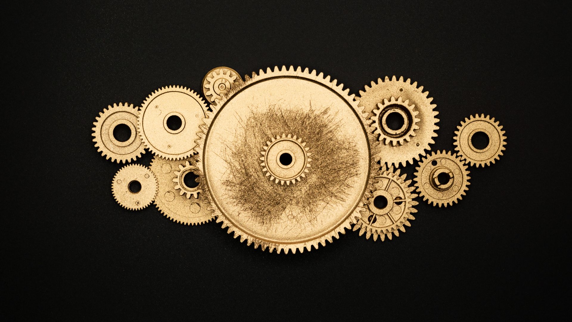 Modafinil's Mechanism of Action: Unlocking the Brain's Potential Artistic arrangement of gold gears on a black background symbolizing industry.