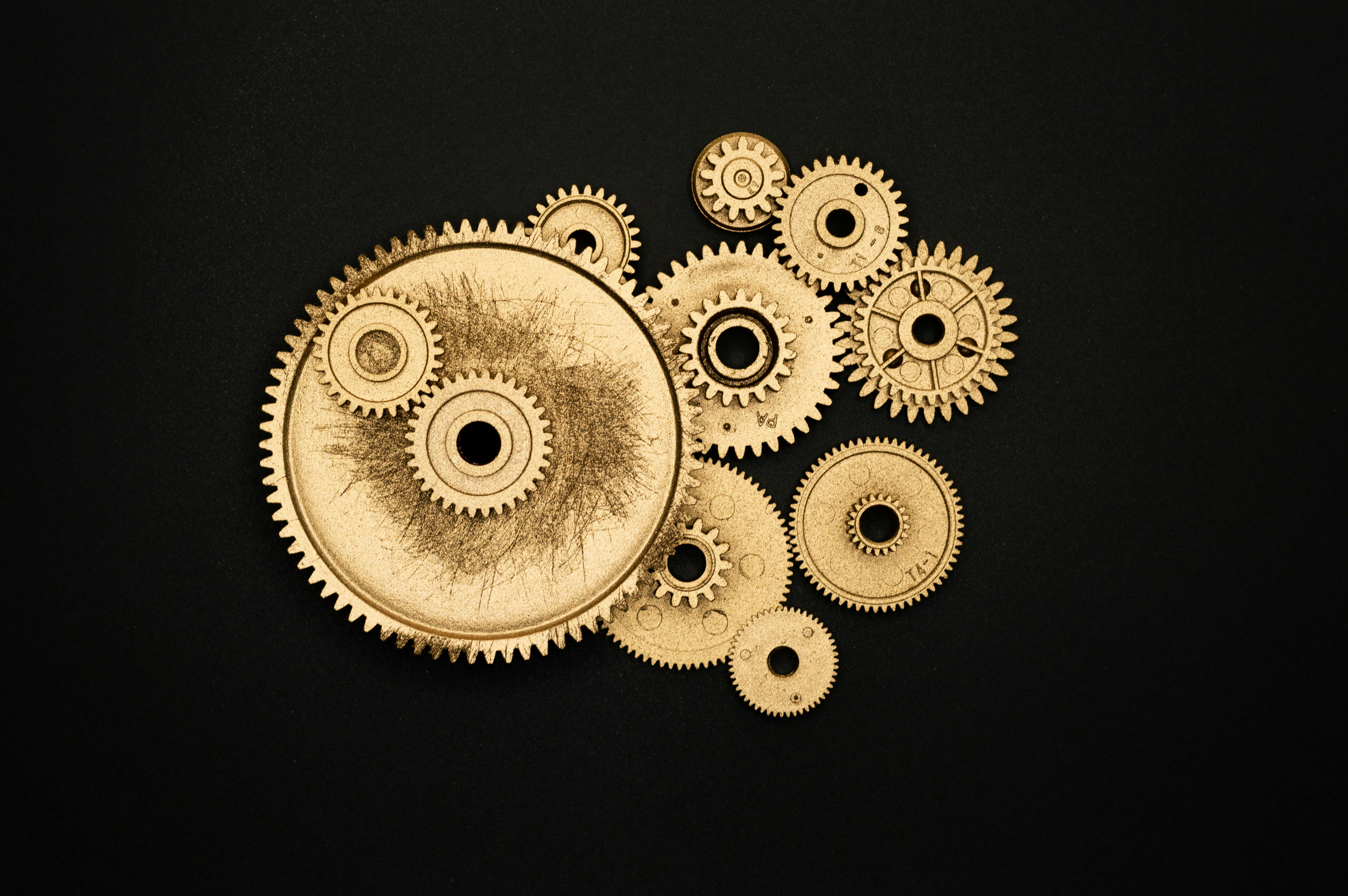 photo of golden cogwheel on black background