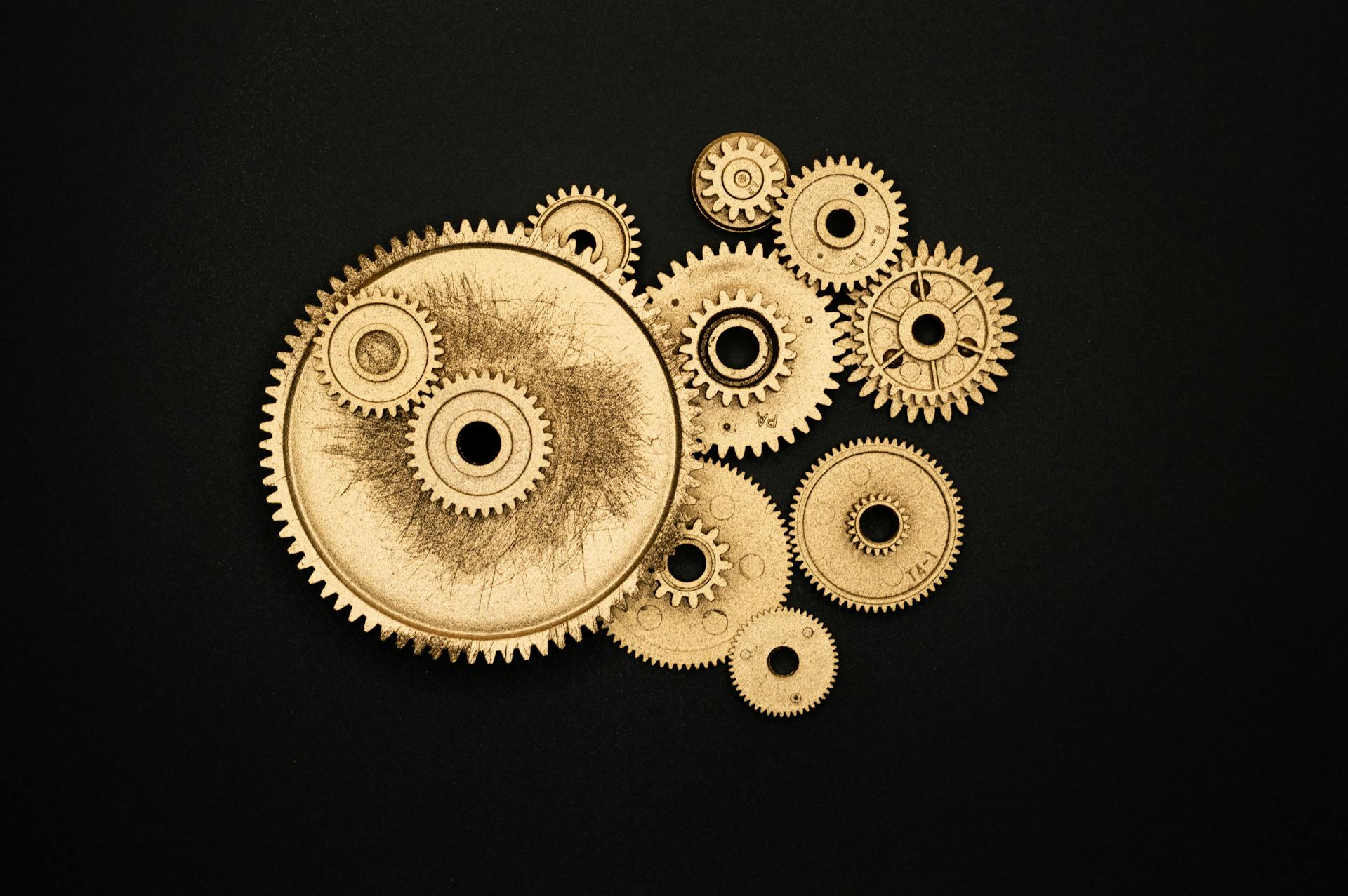 Photo of Golden Cogwheel on Black Background