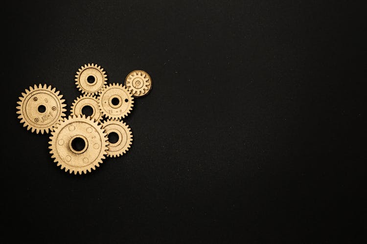 Photo Of Golden Cogwheel On Black Background