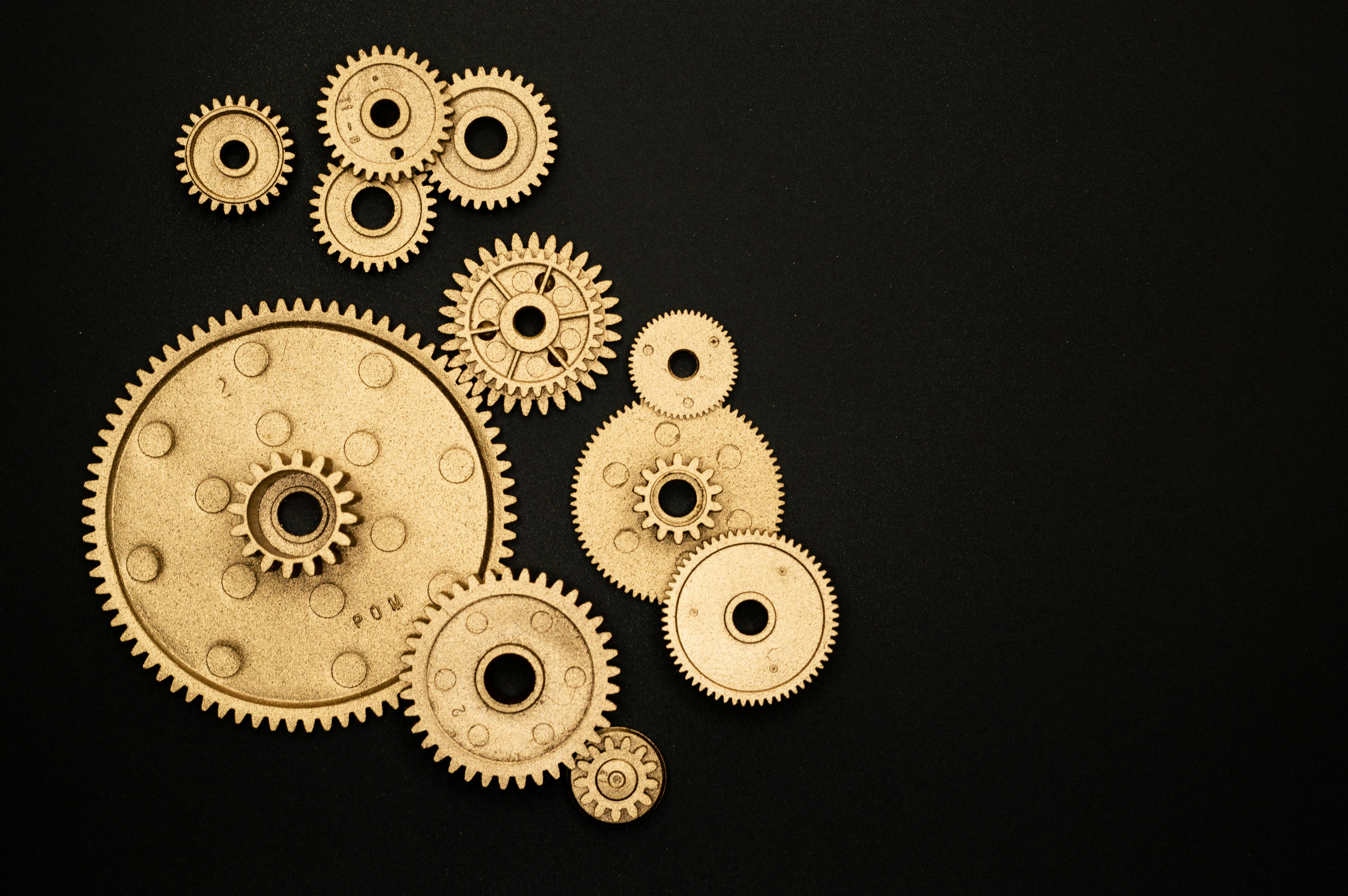 photo of golden cogwheel on black background