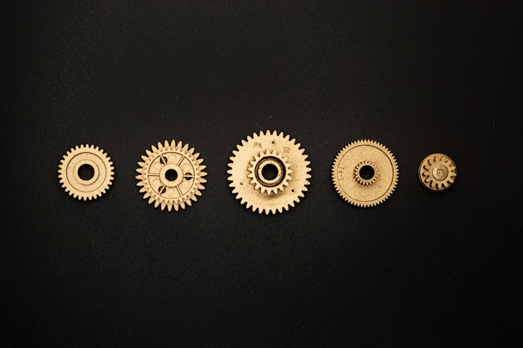 Golden Round Gears On Black Surface