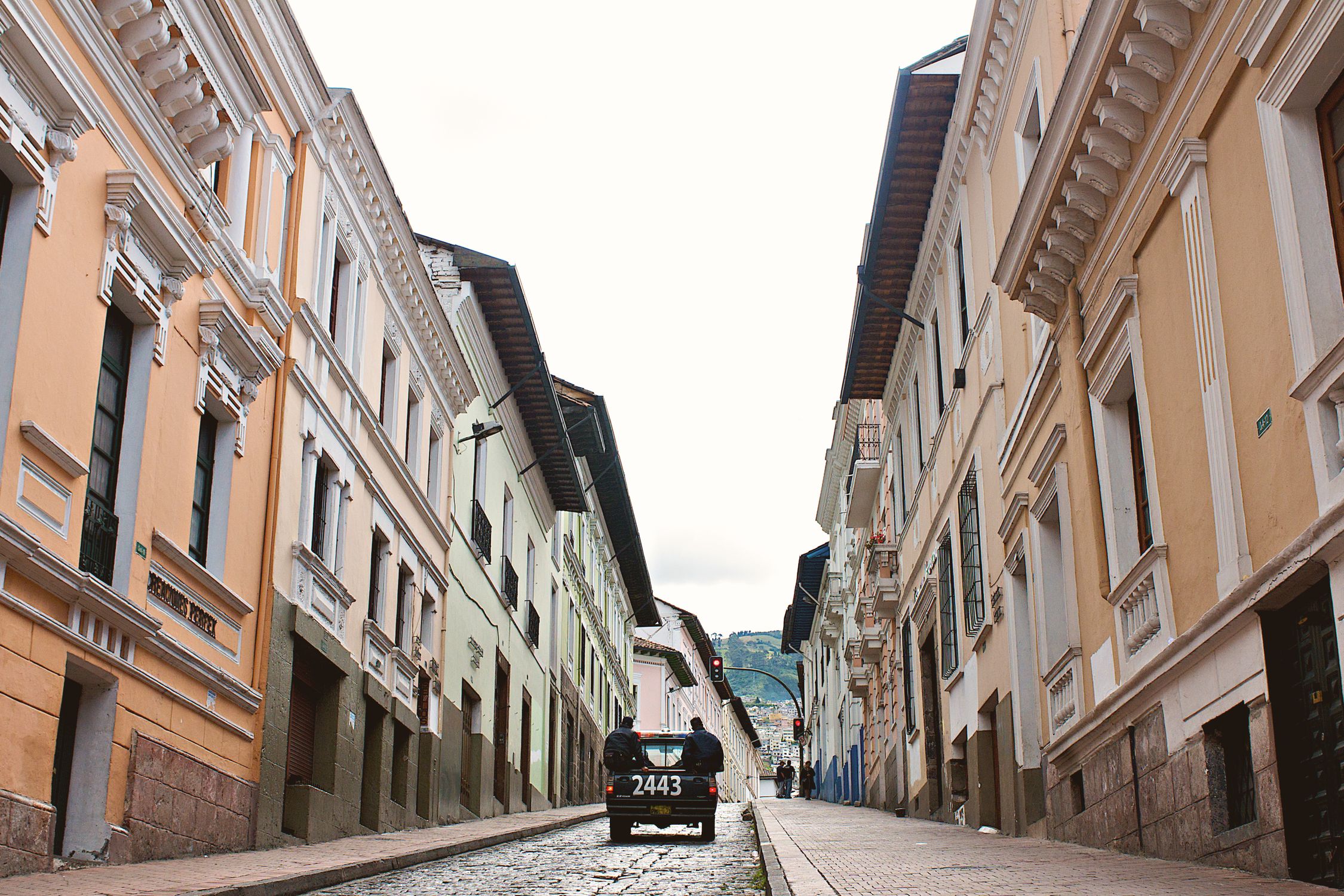 Explore the vibrant colonial architecture of Quito's historic center with colorful facades and cobblestone streets.