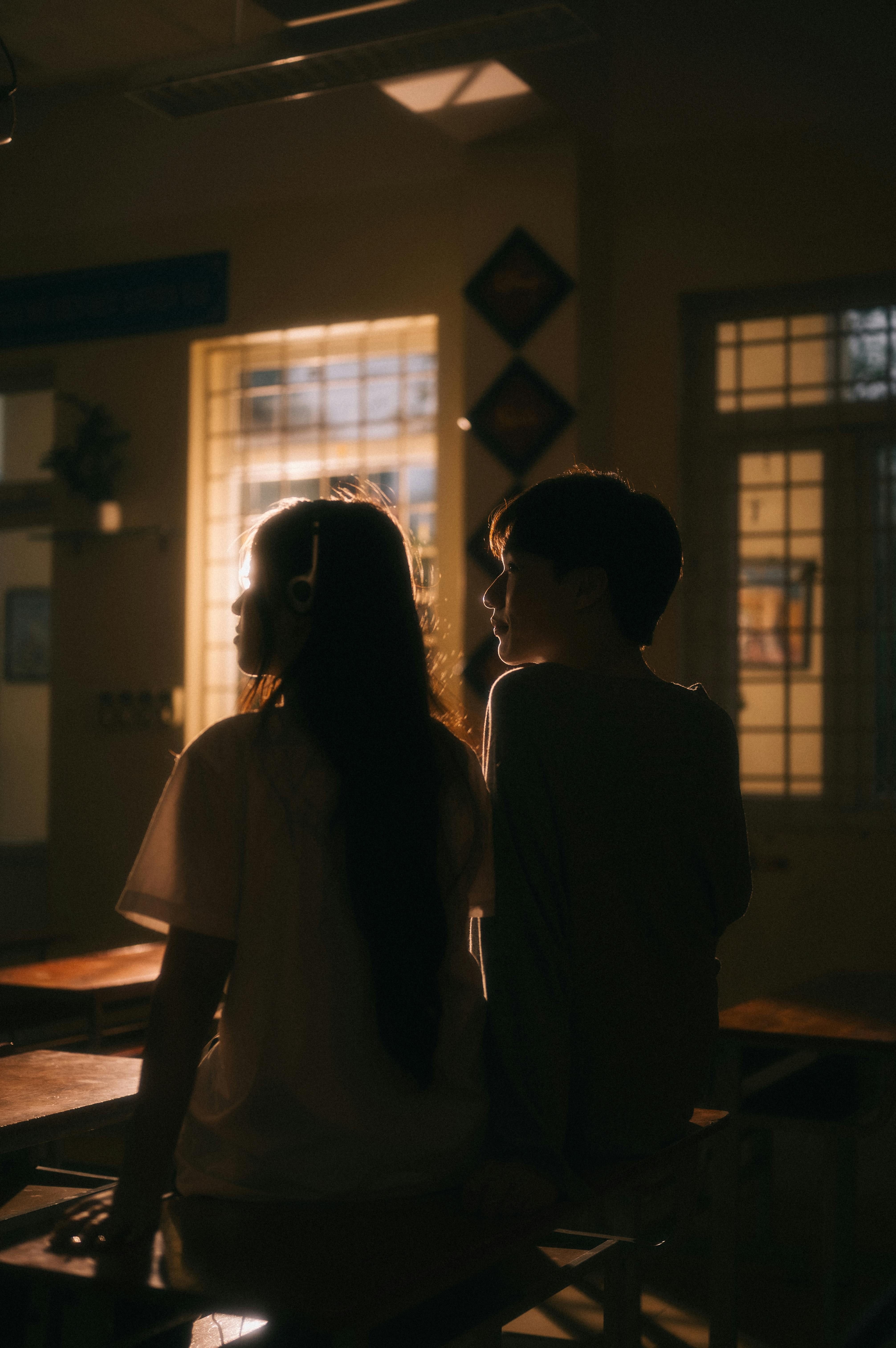 A couple seated indoors in Lạng Sơn, Việt Nam, illuminated by warm sunlight.
