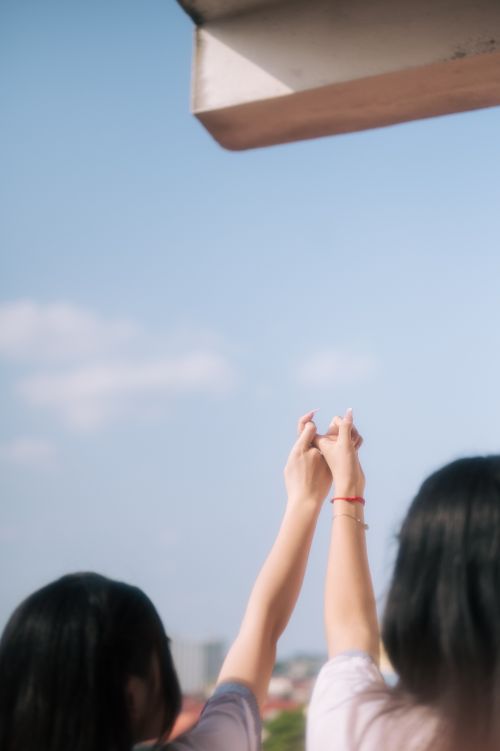Free Two people raise their hands toward the sky in a gesture of hope and unity in Lạng Sơn, Vietnam. Stock Photo