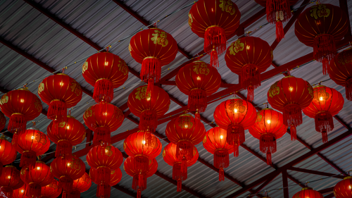 Free Vibrant red Chinese lanterns illuminate the interior space. Stock Photo