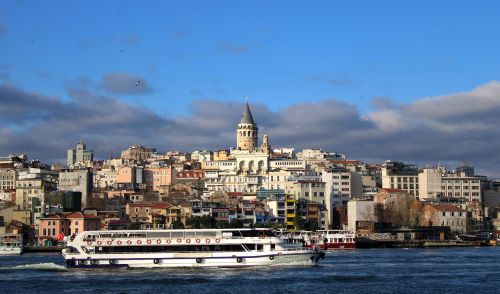 Free A beautiful shot of Galata Tower over Istanbul with a ferry on the Bosphorus. Stock Photo