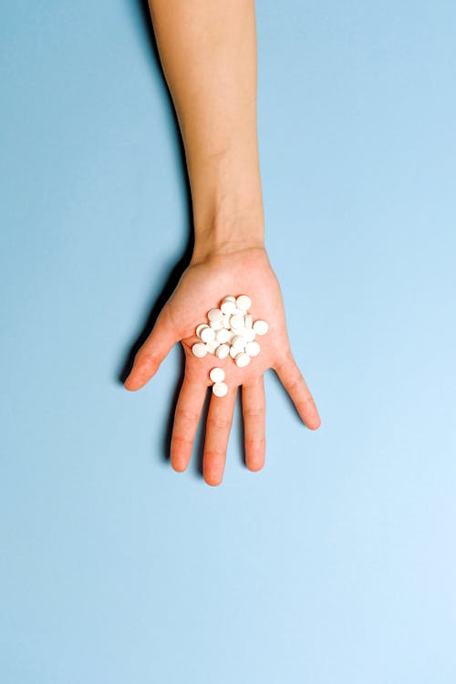 blue aesthetic background hand with pills