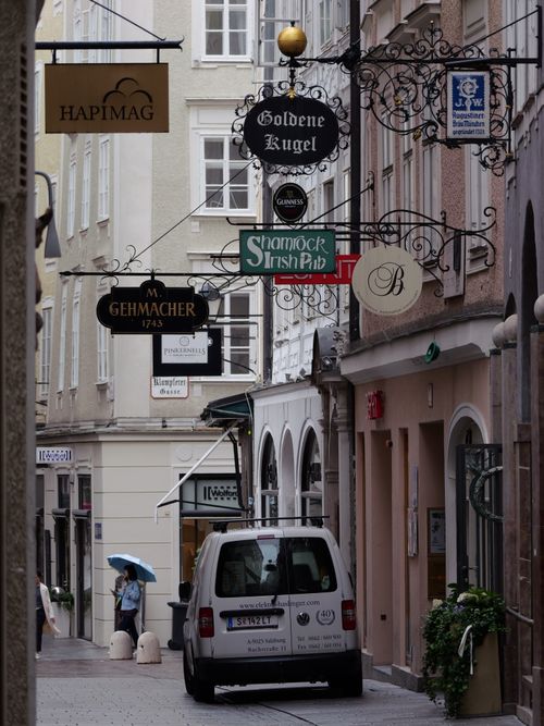 Free A picturesque Salzburg alleyway featuring classic European signage and vibrant street life. Stock Photo