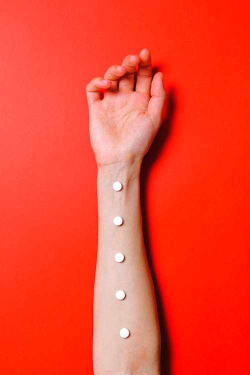 Free Photo of White Pills on Person's Arm Stock Photo