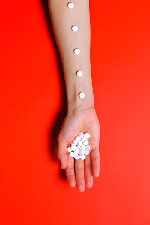 Free Person Holding White Medication Pills Stock Photo