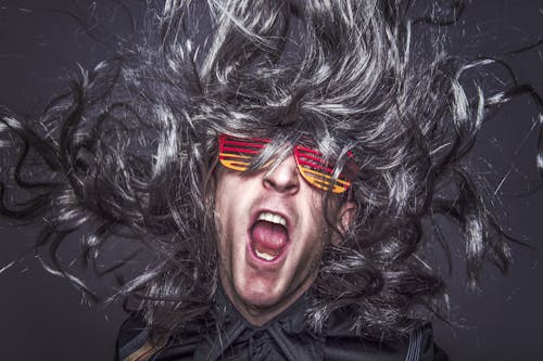 Man Screaming Wearing Red and Yellow Glasses