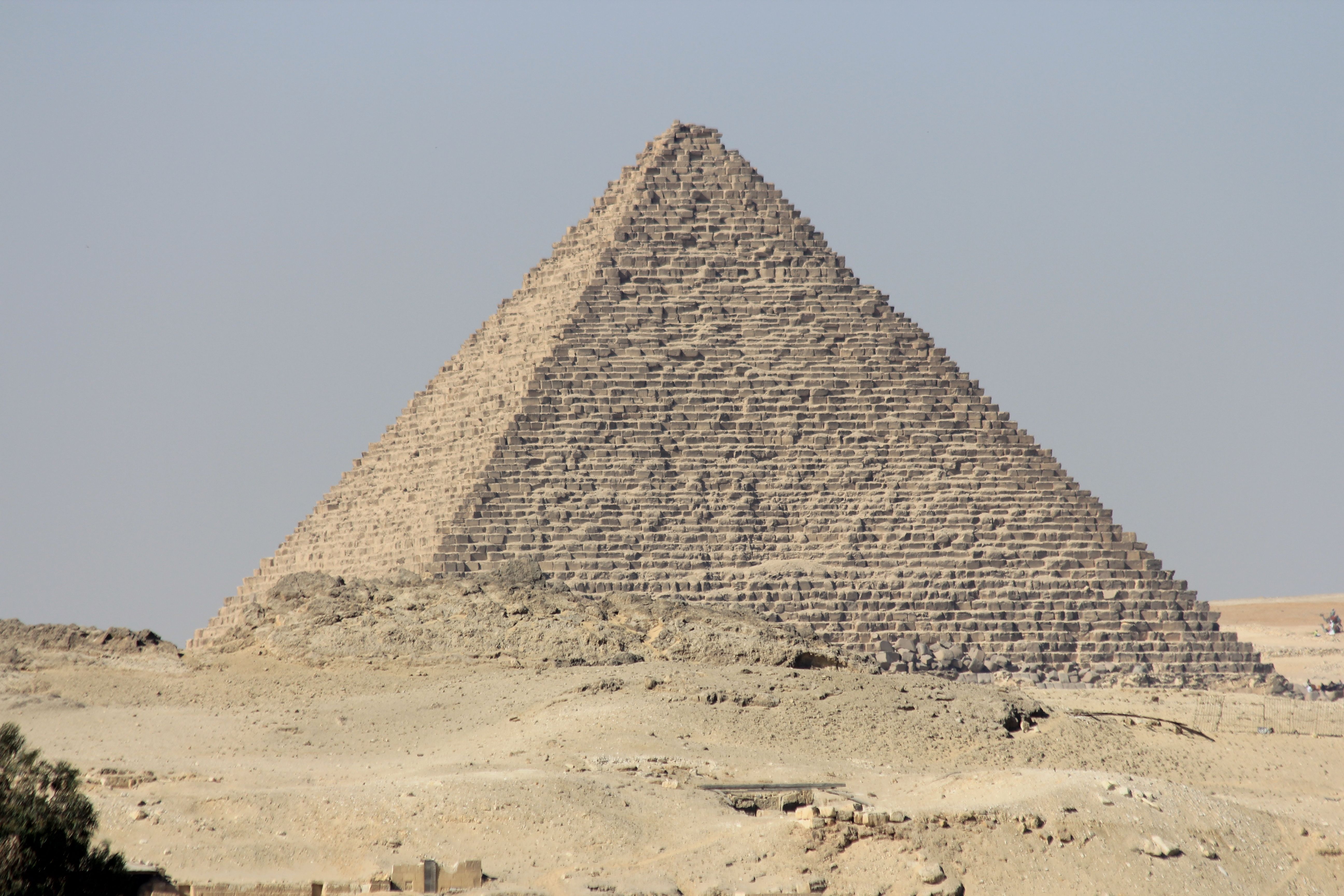 Stunning view of the Pyramid of Khufu, Giza, under a bright blue sky, showcasing ancient Egyptian architecture.
