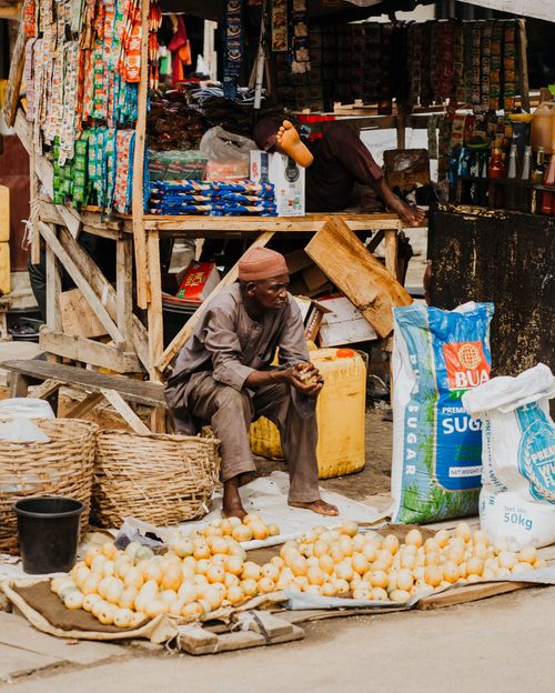 Free A street vendor selling onions at an outdoor market stall in Africa, local commerce scene. Stock Photo