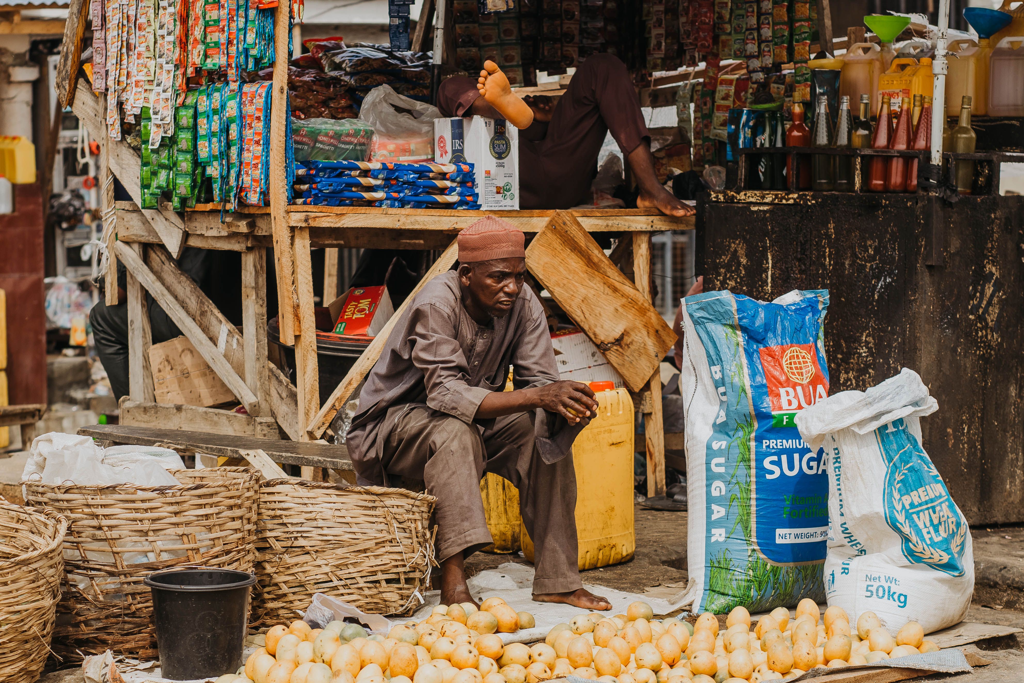 Street Vendor Selling Produce in Outdoor Market · Free Stock Photo