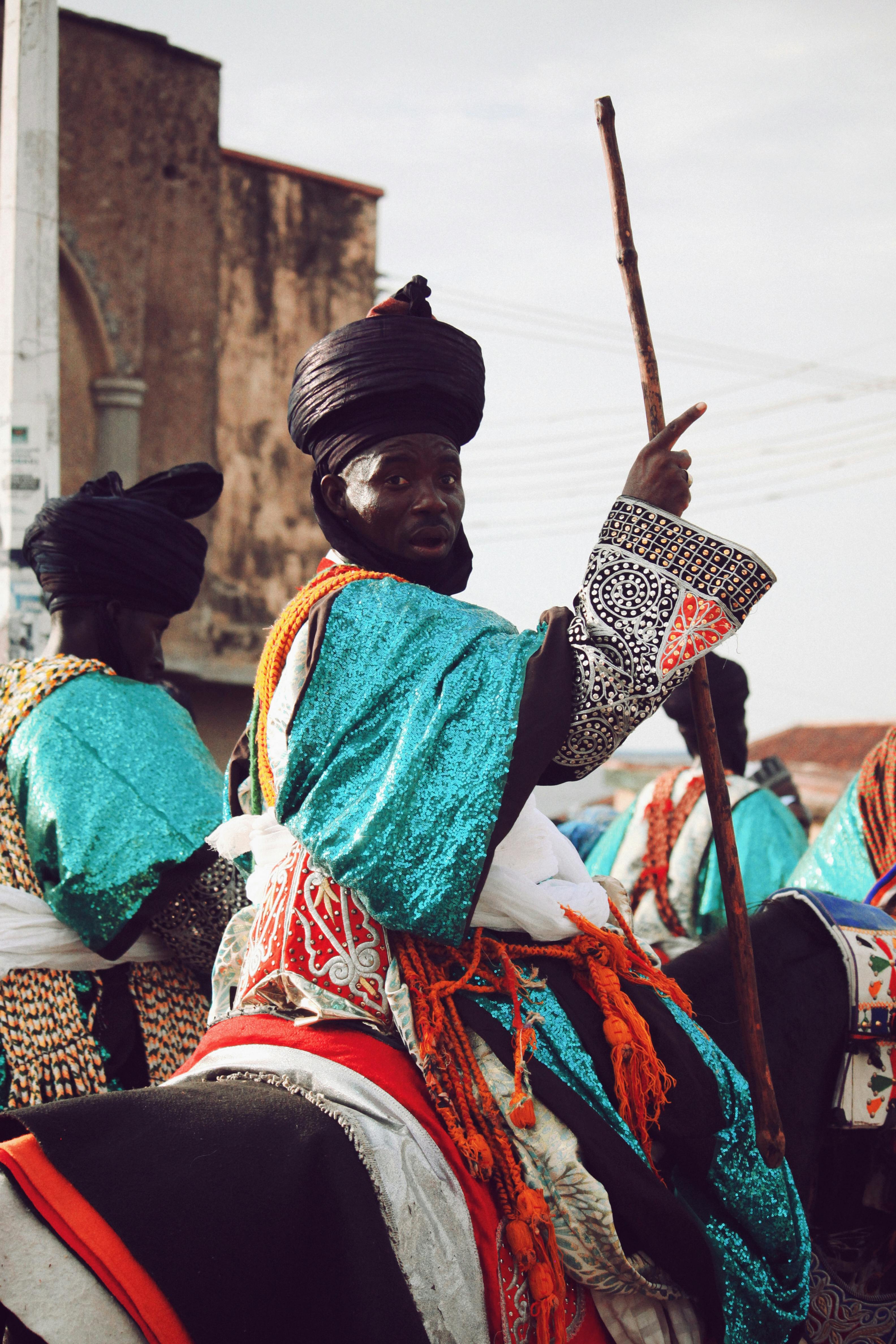 Traditional horsemen in Zaria, Nigeria, wearing colorful attire during a cultural event.