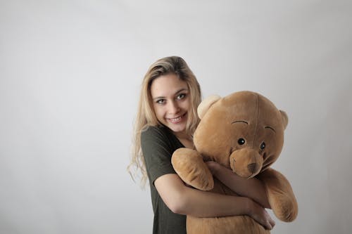 Woman Hugging a Bear Stuff Toy