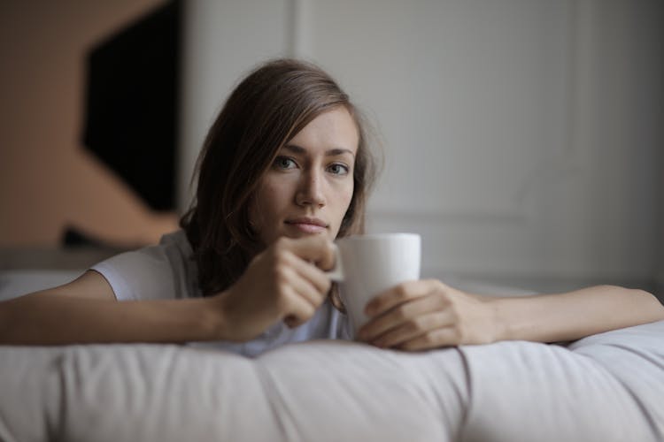 Woman In White Shirt Holding White Ceramic Mug