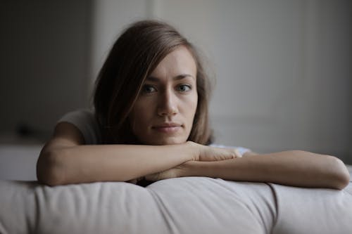 Free Woman Lying on Bed With White Pillow Stock Photo
