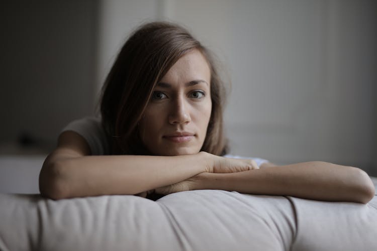 Woman Lying On Bed With White Pillow