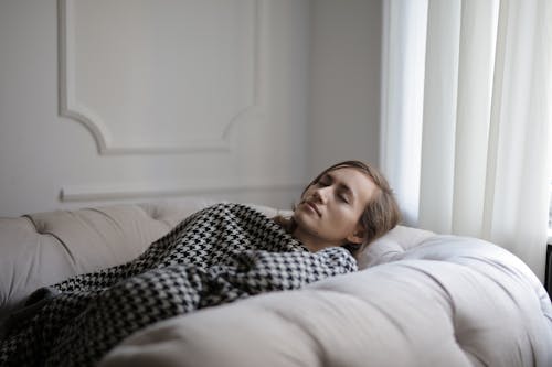 Free Woman Lying on Couch Stock Photo