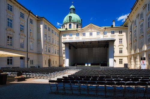 Free Outdoor stage setup in a historic courtyard in Innsbruck, perfect for open-air events. Stock Photo