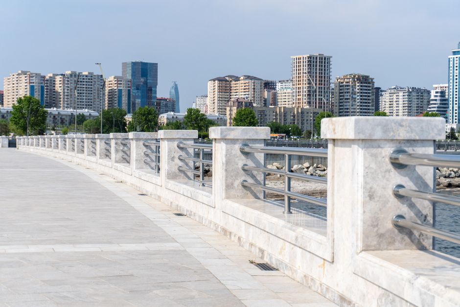 People walking along the windy Baku promenade by the Caspian Sea in Azerbaijan