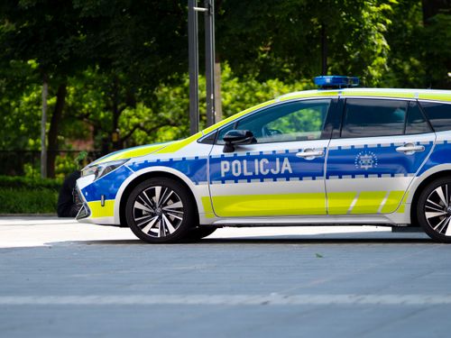 Free Polish police car parked outdoors in Wrocław, Poland, showcasing European law enforcement vehicle design. Stock Photo