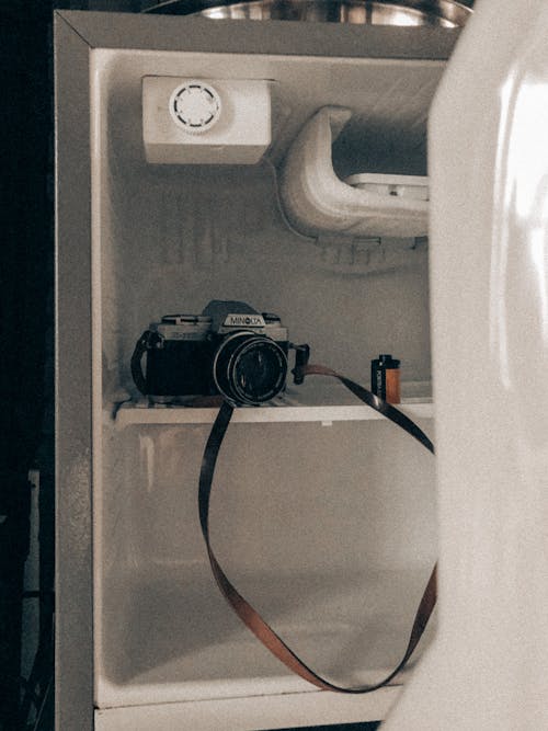 Free Black Nikon Dslr Camera Inside a Refrigerator Stock Photo