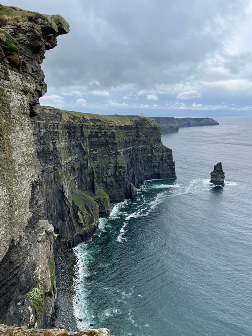 Free Breathtaking view of the Cliffs of Moher along the Irish coastline under a cloudy sky. Stock Photo