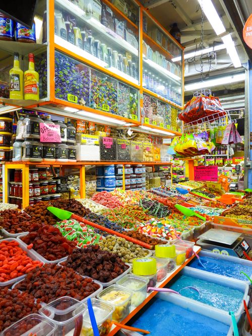 Free Colorful candy and spice market stall in Mexico City, highlighting diverse offerings with vivid packaging. Stock Photo