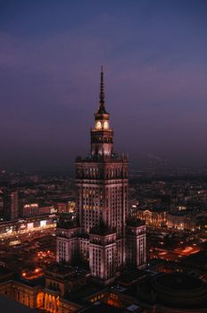 Stunning aerial shot of the Palace of Culture and Science in Warsaw at twilight.