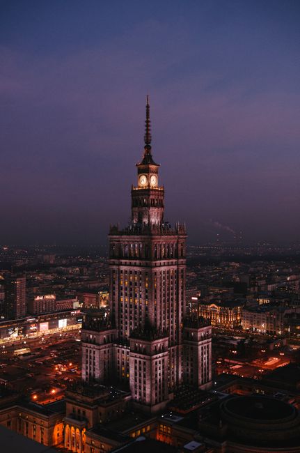 Stunning aerial shot of the Palace of Culture and Science in Warsaw at twilight.