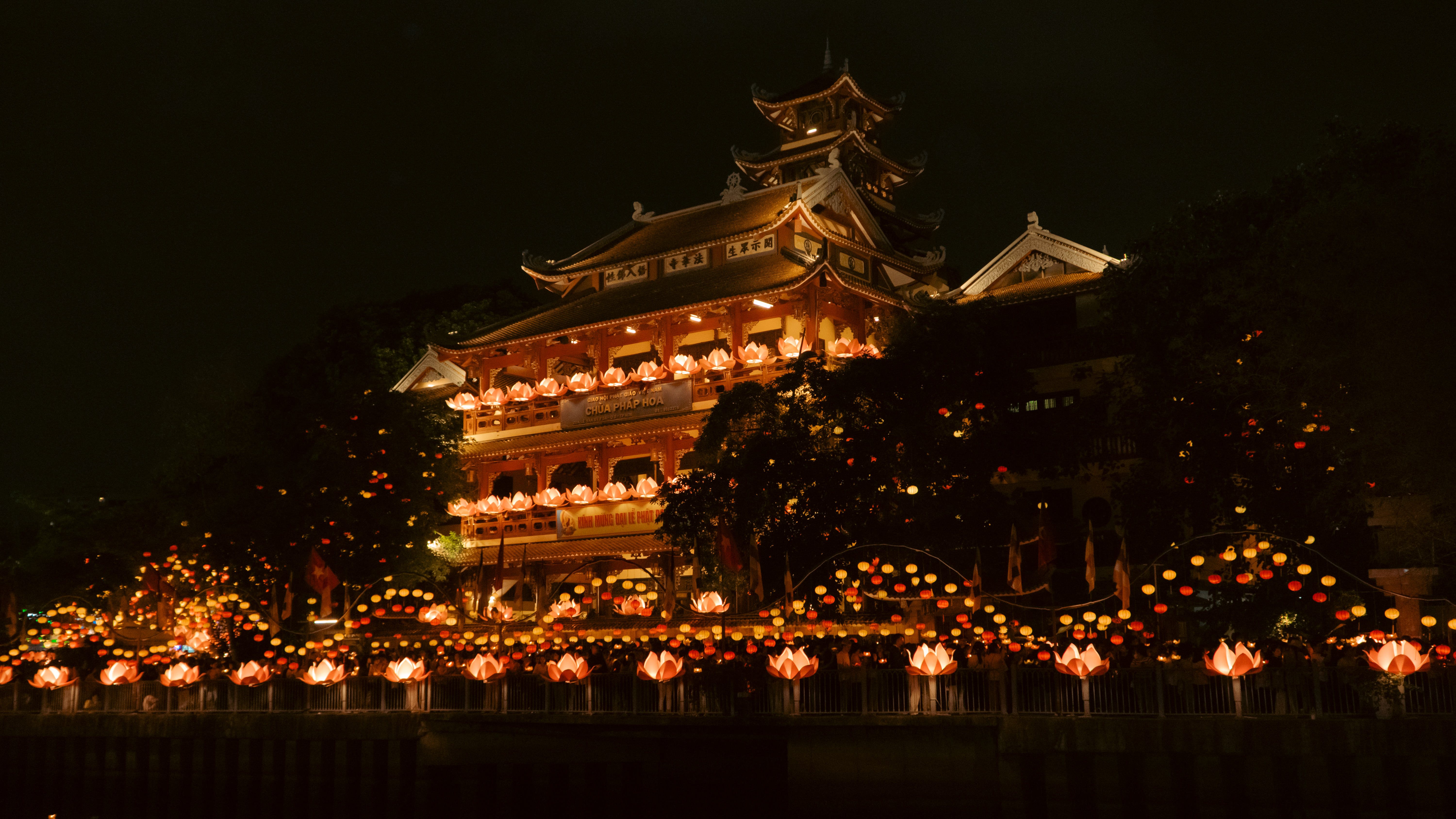 Illuminated temple adorned with colourful lanterns during a festival