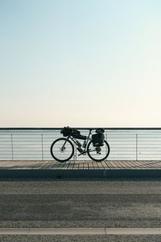 Bicycle packed for an adventure by the ocean at Le Mont-Saint-Michel, France.
